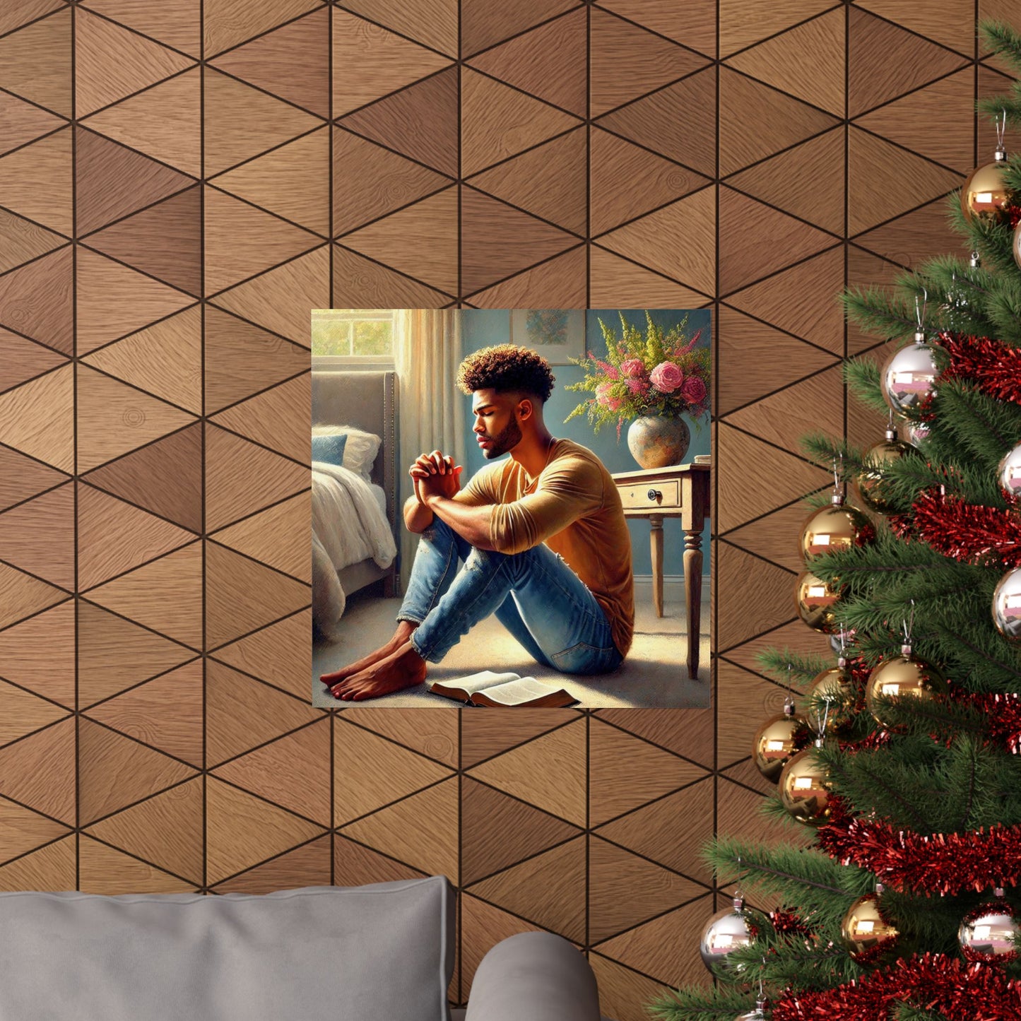 Man sitting on the floor with a Christmas tree and geometric wall design in the background