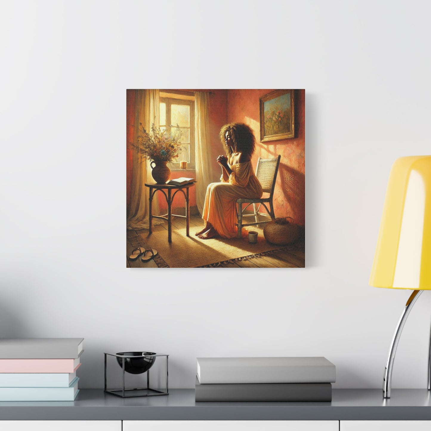 Canvas print of a black woman sitting by a window in a warm-toned room, displayed on a wall above a shelf.