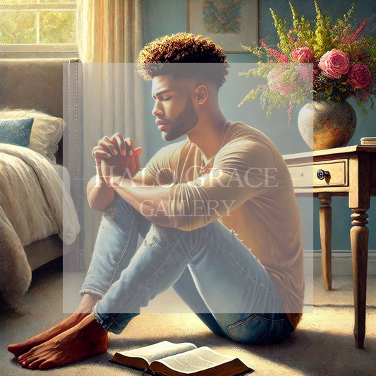Black Man sitting on the floor with a bible, praying.
